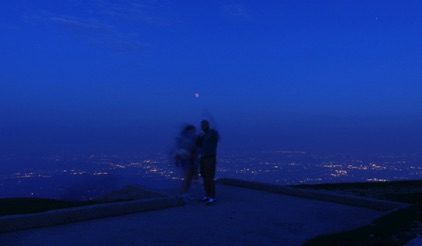a couple enjoys the total lunar eclipse from the summit